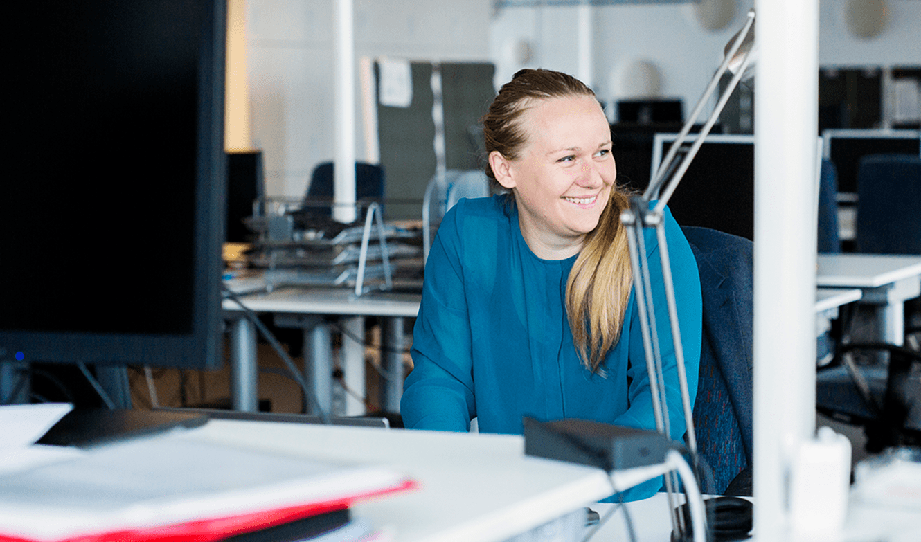 smiling-woman-sitting-in-office-2024-10-18-05-19-59-utc_crop