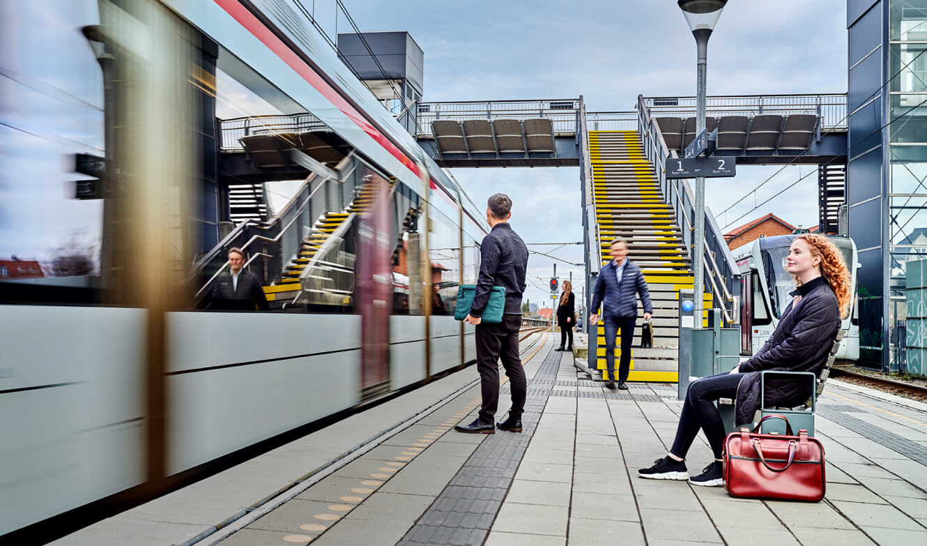 Image of a train station with people looking at the train.